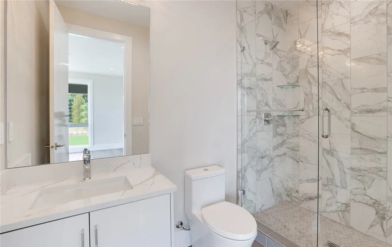 Marble walk-in shower and vanity