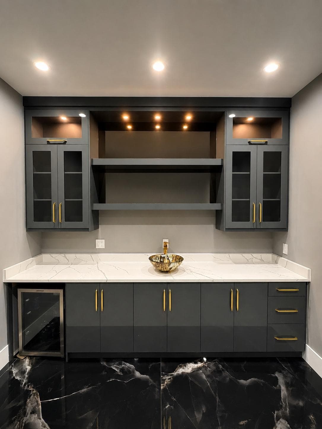 Wet bar with black marble and gold fixtures